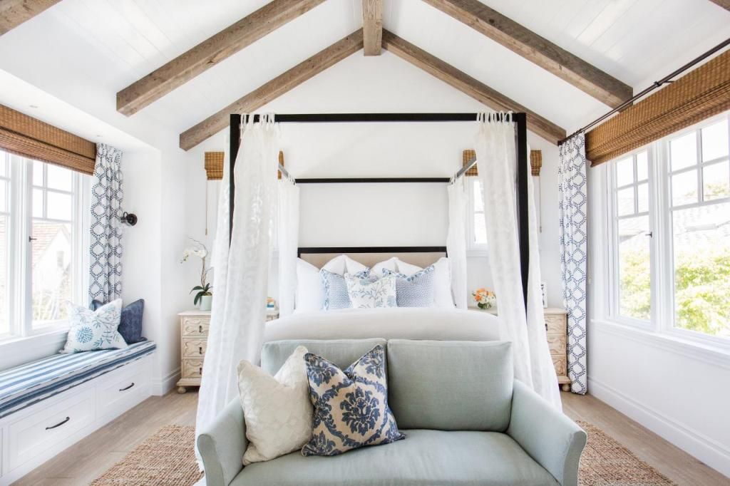 Chic vaulted master bedroom with wood beams